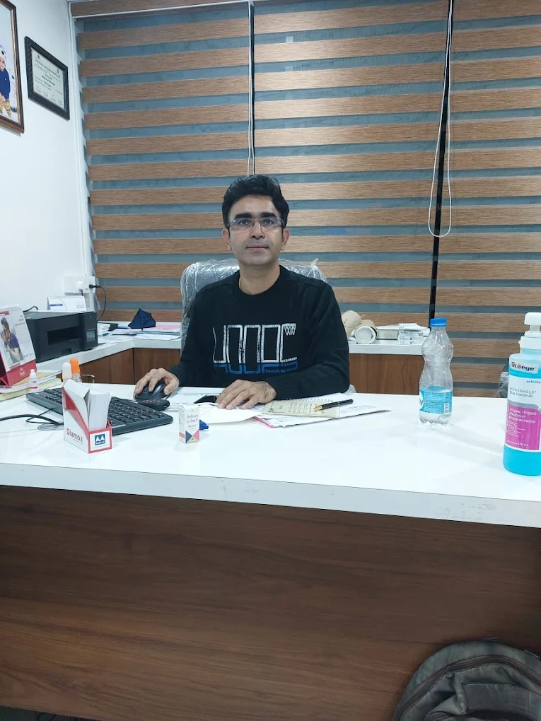 Dr. Punit Singh sitting at his consultation desk in Vijay Eye Hospital
