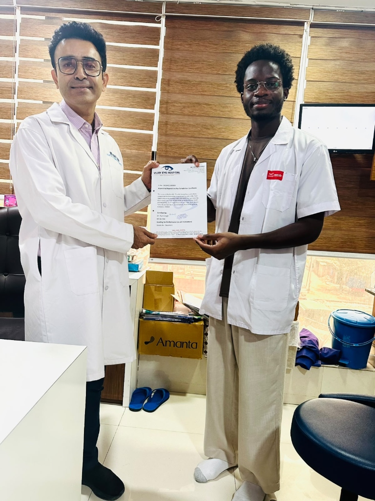 Ophthalmology student receiving clinical training completion certificate from Dr. Punit Singh